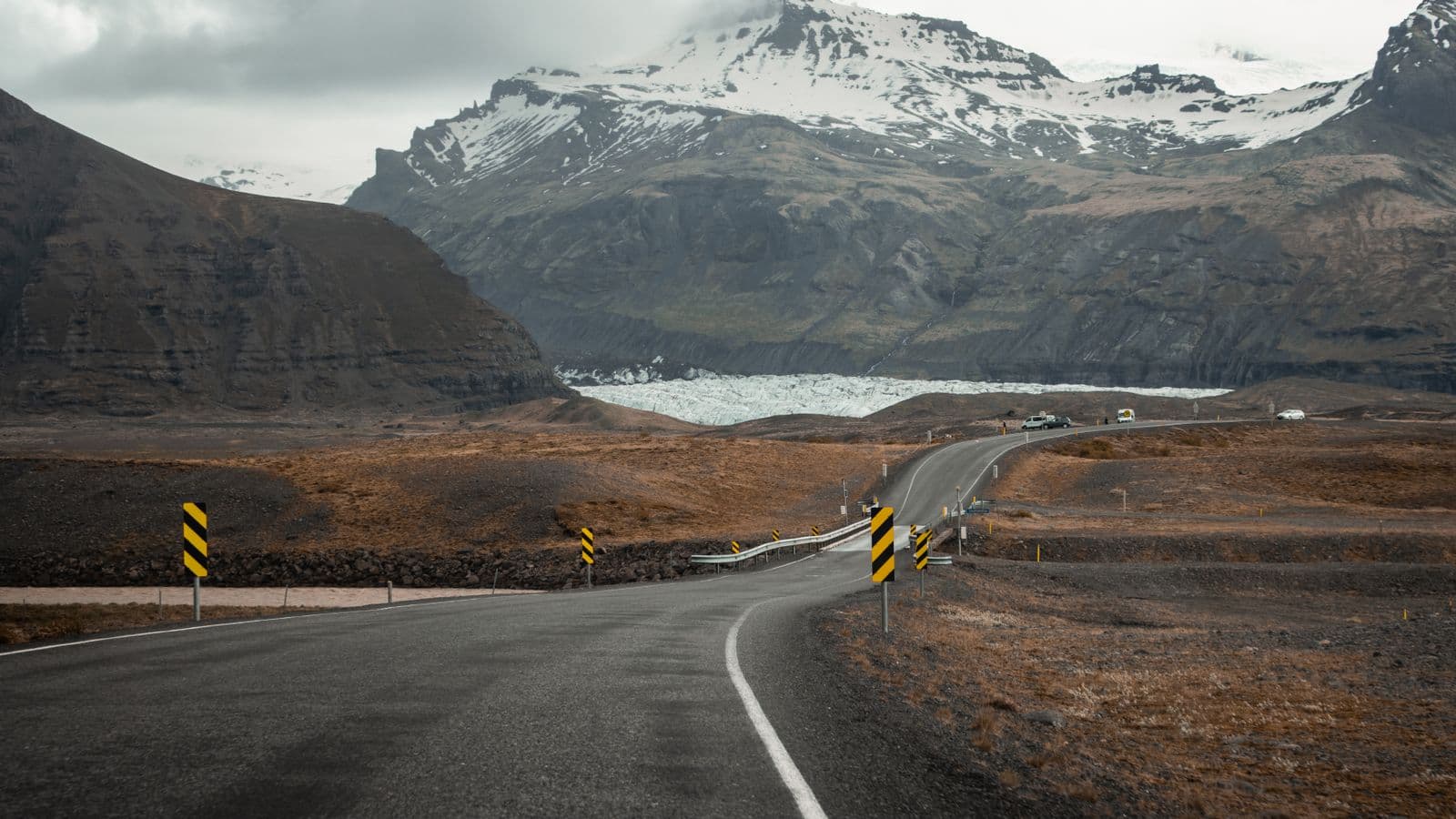 Road running between green mountains near Vík in southern Iceland