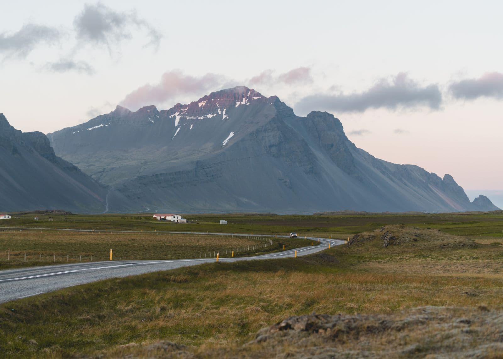 Winding road through Icelandic mountains at twilight