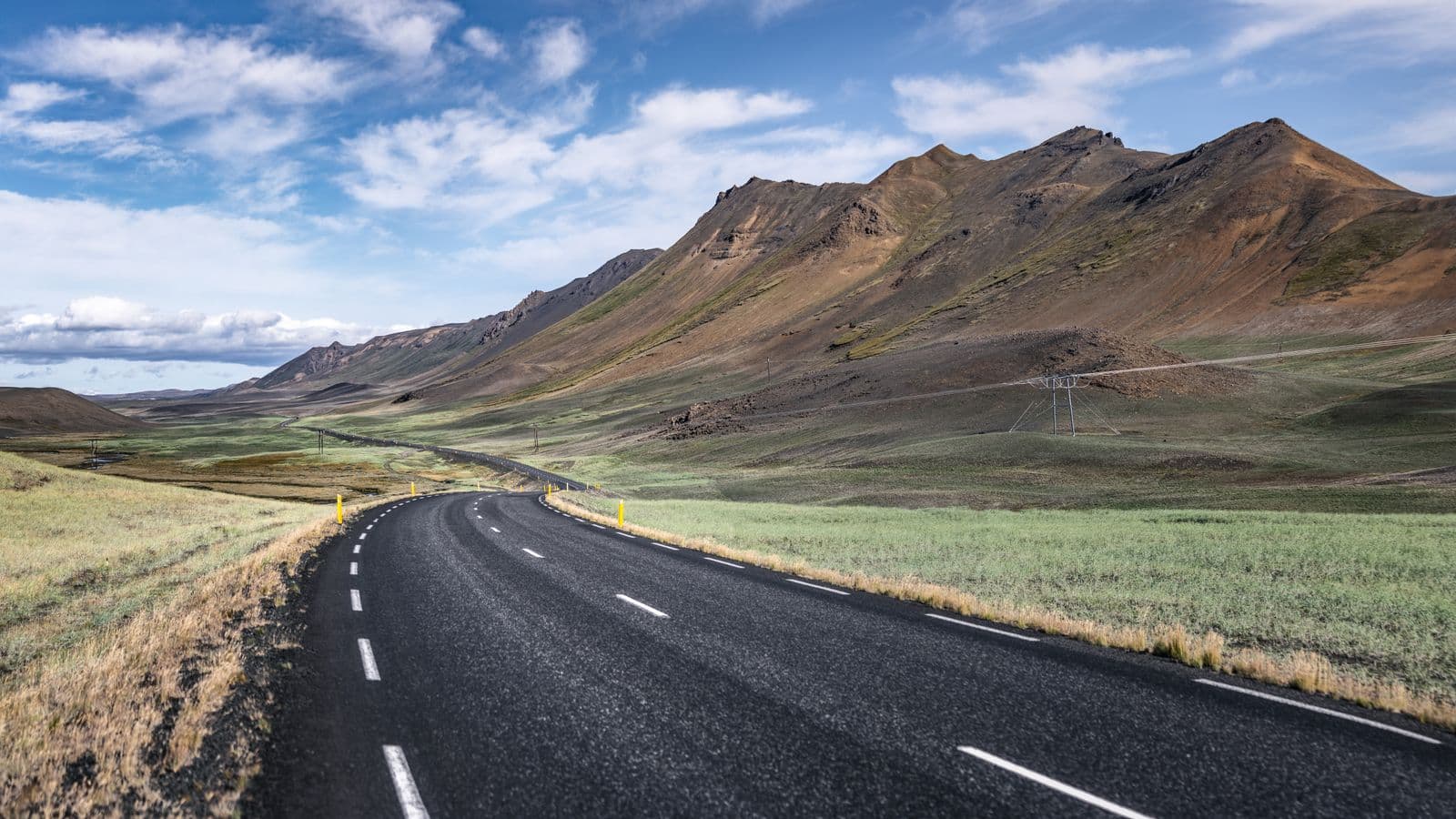 Empty road winding through the Icelandic mountains and countryside