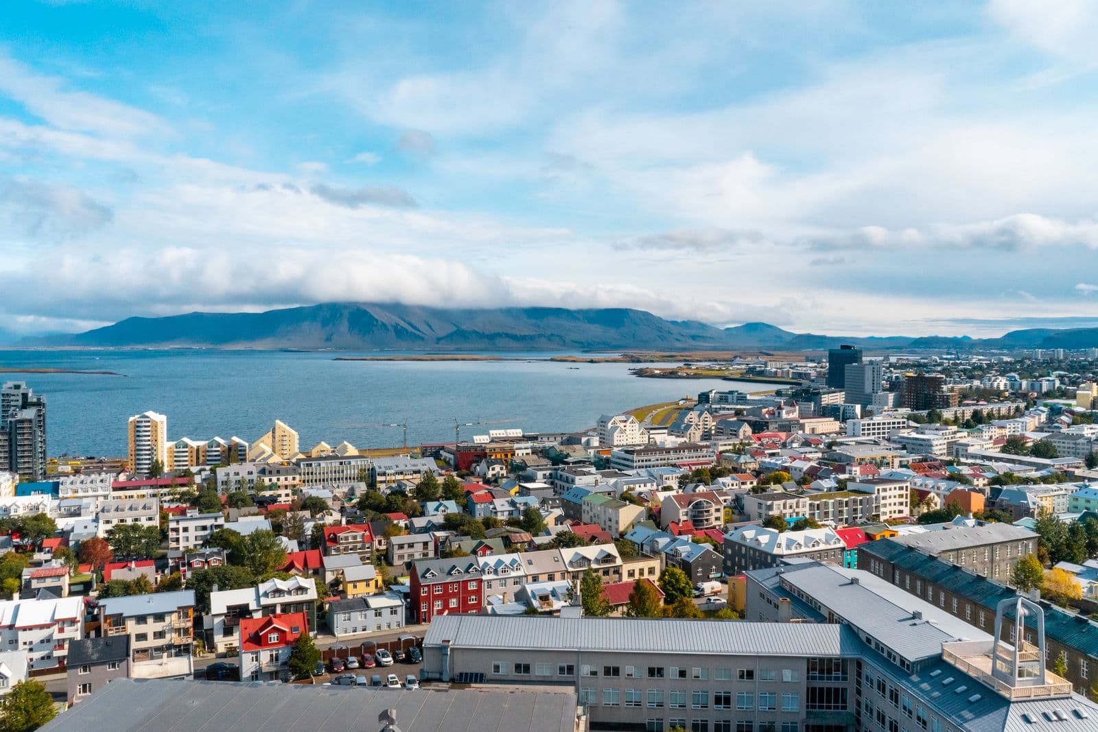 Colourful rooftops of central Reykjavík with the sea and mountains beyond