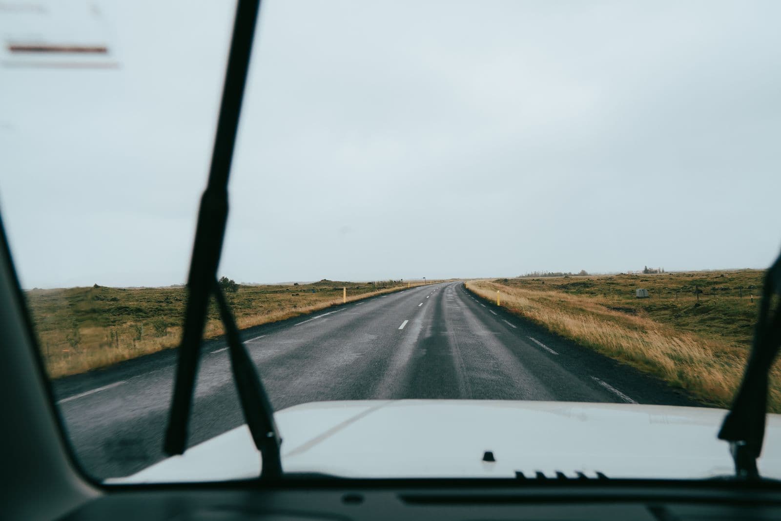 View through a car windscreen of a scenic Icelandic road ahead