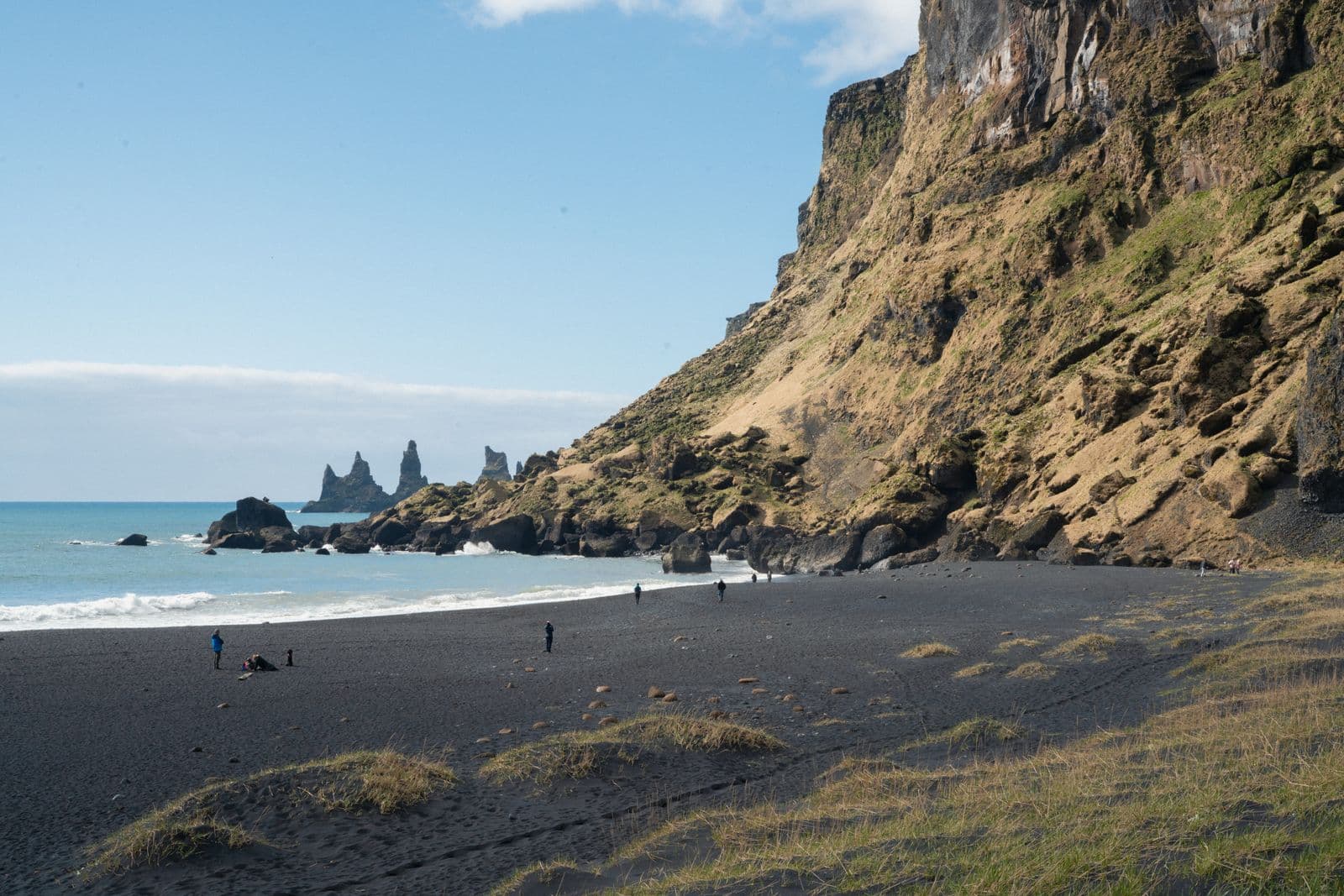 Reynisfjara black sand beach in Iceland with basalt columns and dark volcanic sand